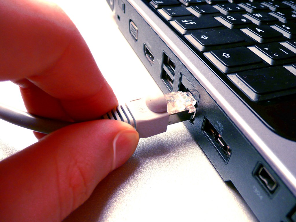 A USB cable being unplugged from a computer.